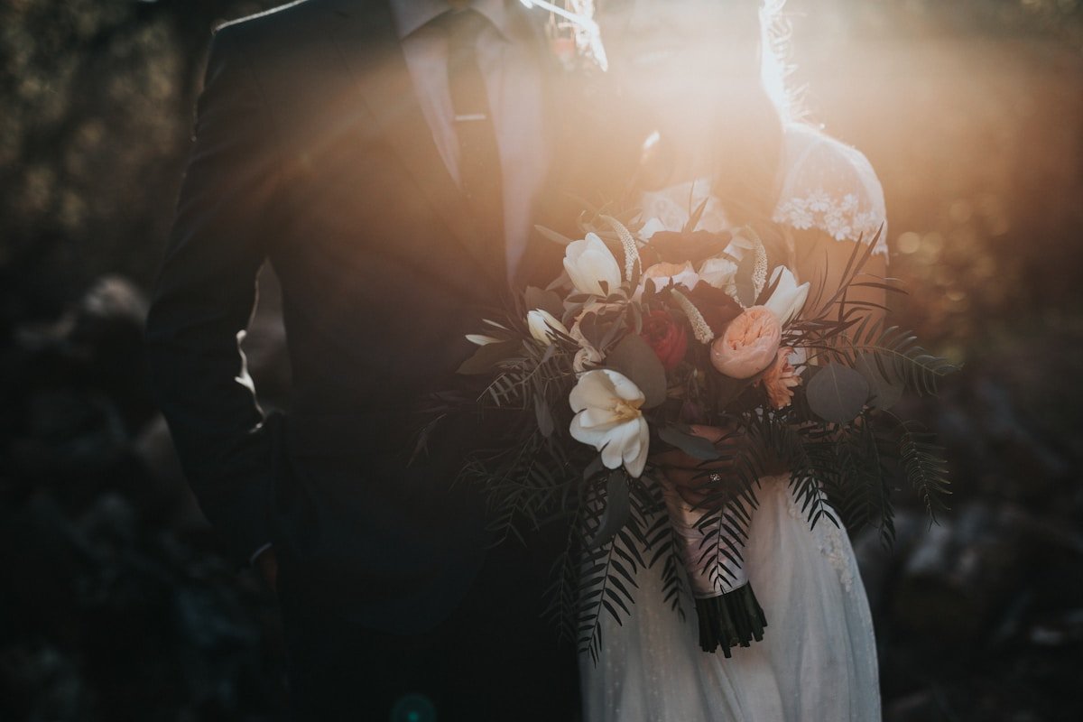 Elegant event setup with tables, floral centerpieces and warm lighting